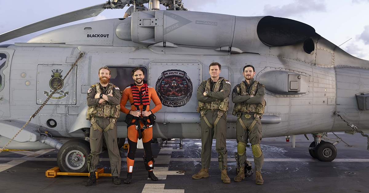 (L-R) Lieutenant Noah Learoyd, RAN, Leading Seaman Aircrewman Justin Howes, Lieutenant James Craig, RAN and Leading Seaman Aircrewman Daniel Heuston after conducting a successful Search and Rescue with HMAS Supply's embarked MH-60R Seahawk helicopter during Regional Presence Deployment 2026. Image: © Australian Defence Force