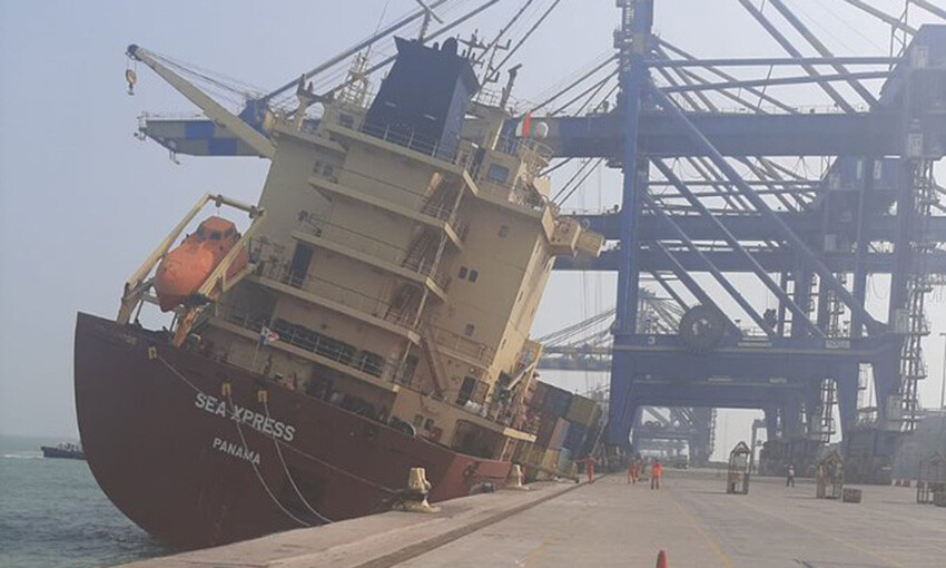 Ship lists, spills boxes at port